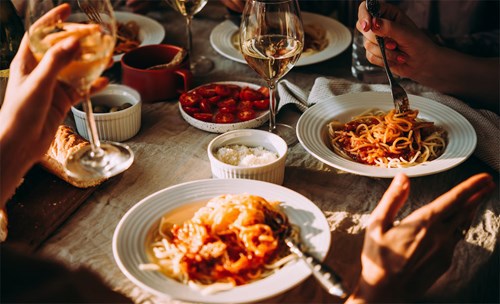 People enjoying food and wine together