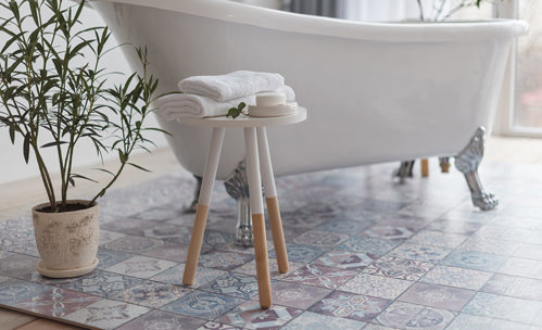 Bathroom interior - White bath, and towels and soap on a small table