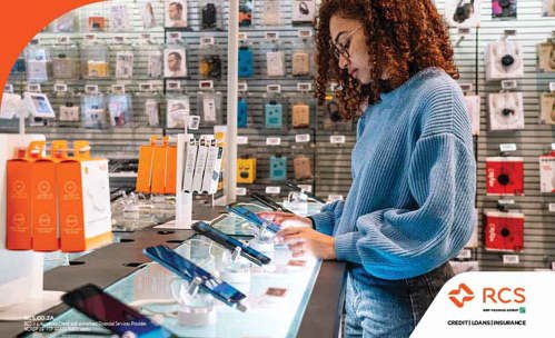 Woman looking at phone in tech store